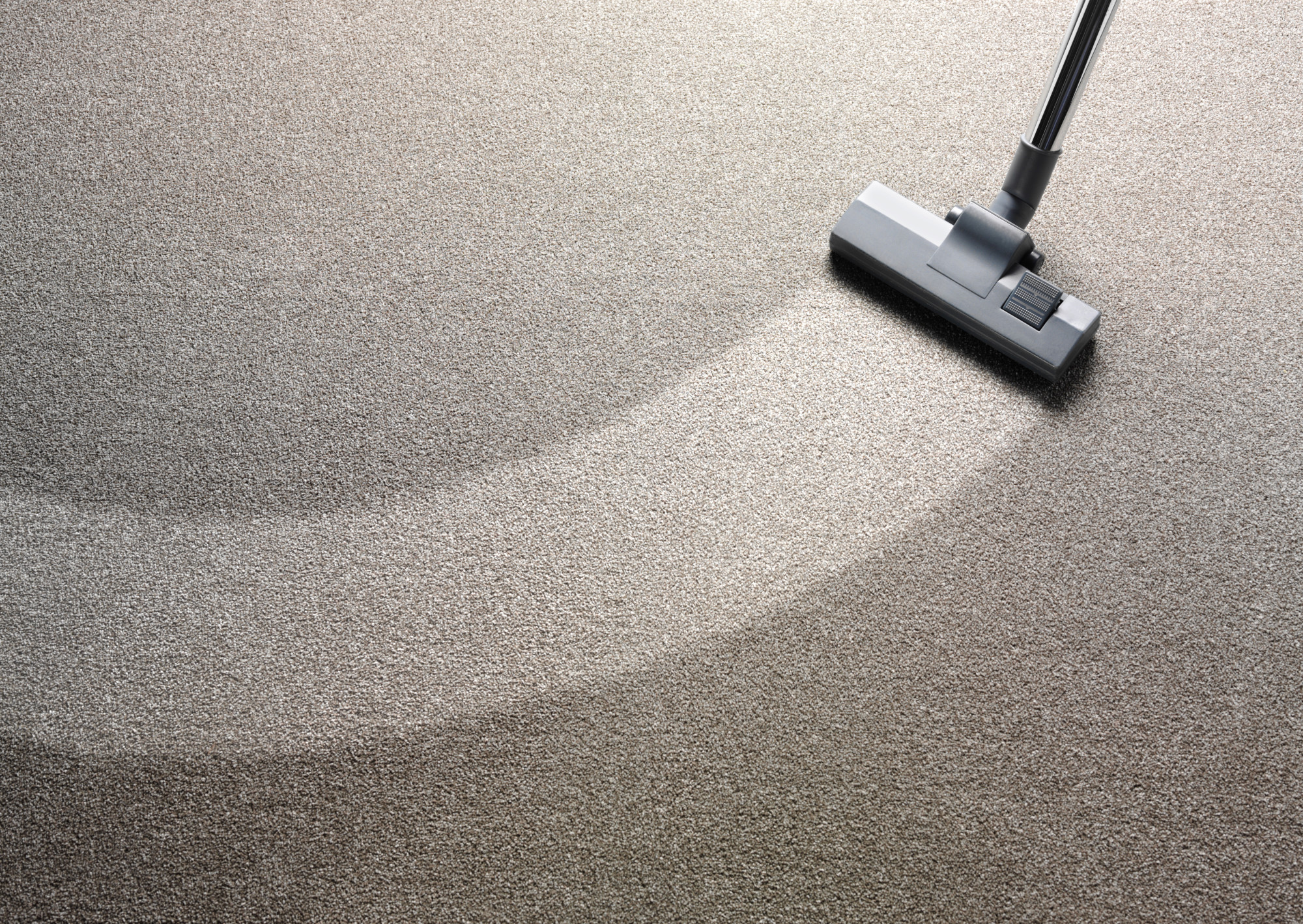 Vacuum cleaner on a carpet with an extra clean strip