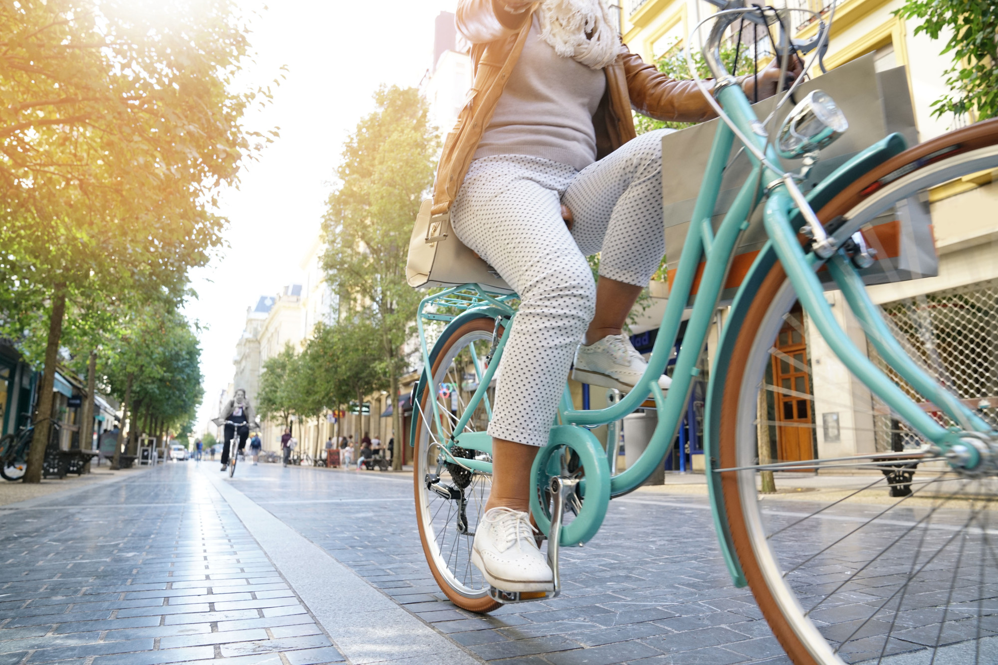 woman riding bike instead of driving car